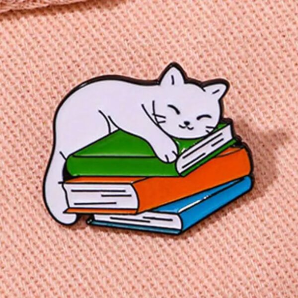 Sleepy Cat on Books enamel pin